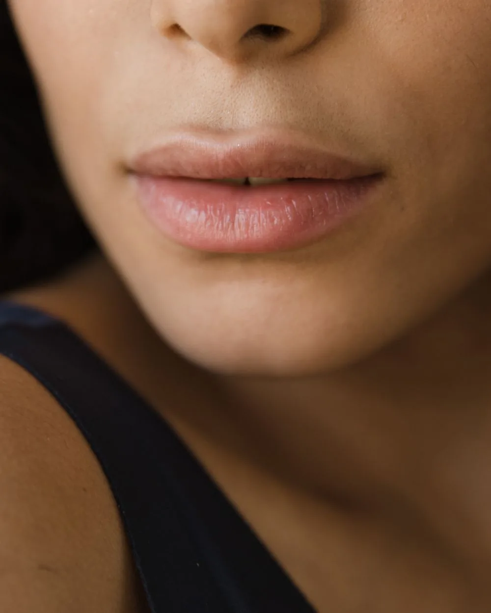 A close-up of a person’s lips and lower face.
