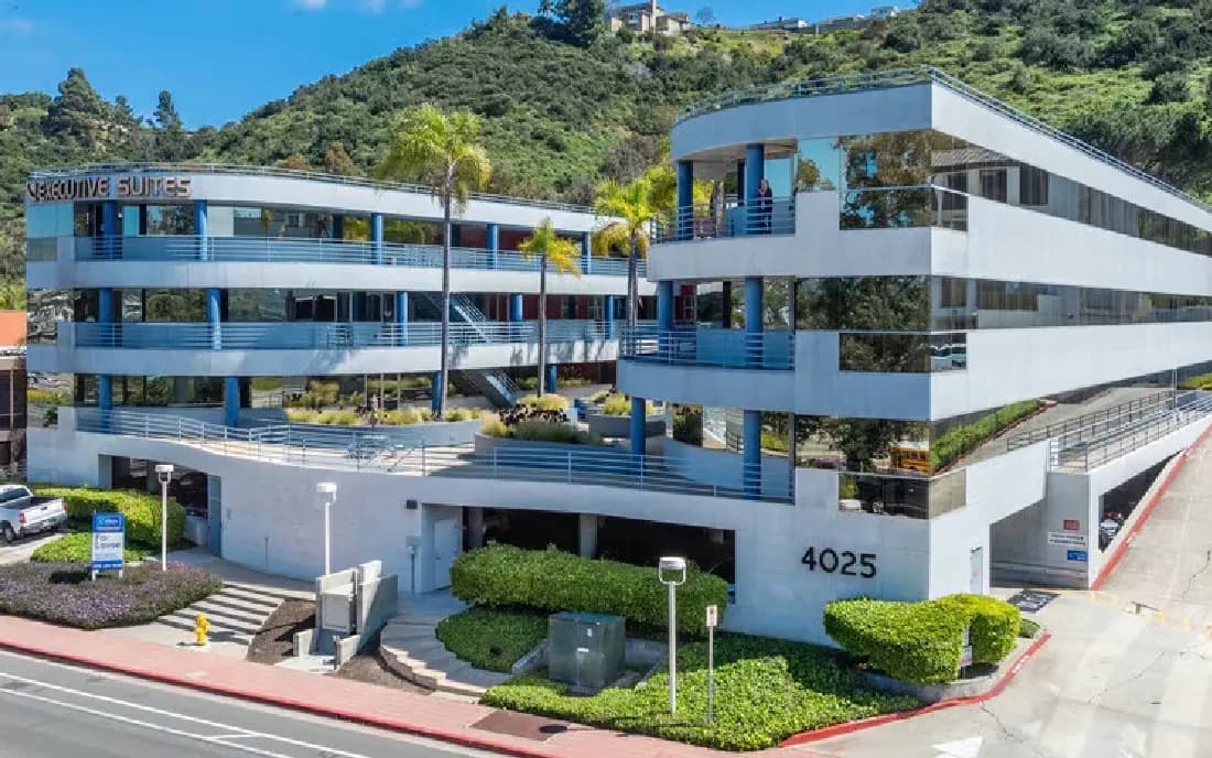 The office building at 4025 Camino Del Rio South, its street number above the ground-floor entrance.